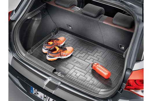 A pair of shoes and a fire extinguisher are in the trunk of a car.