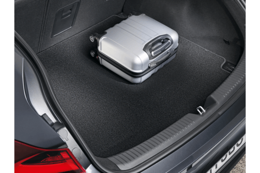 A suitcase is sitting in the trunk of a car