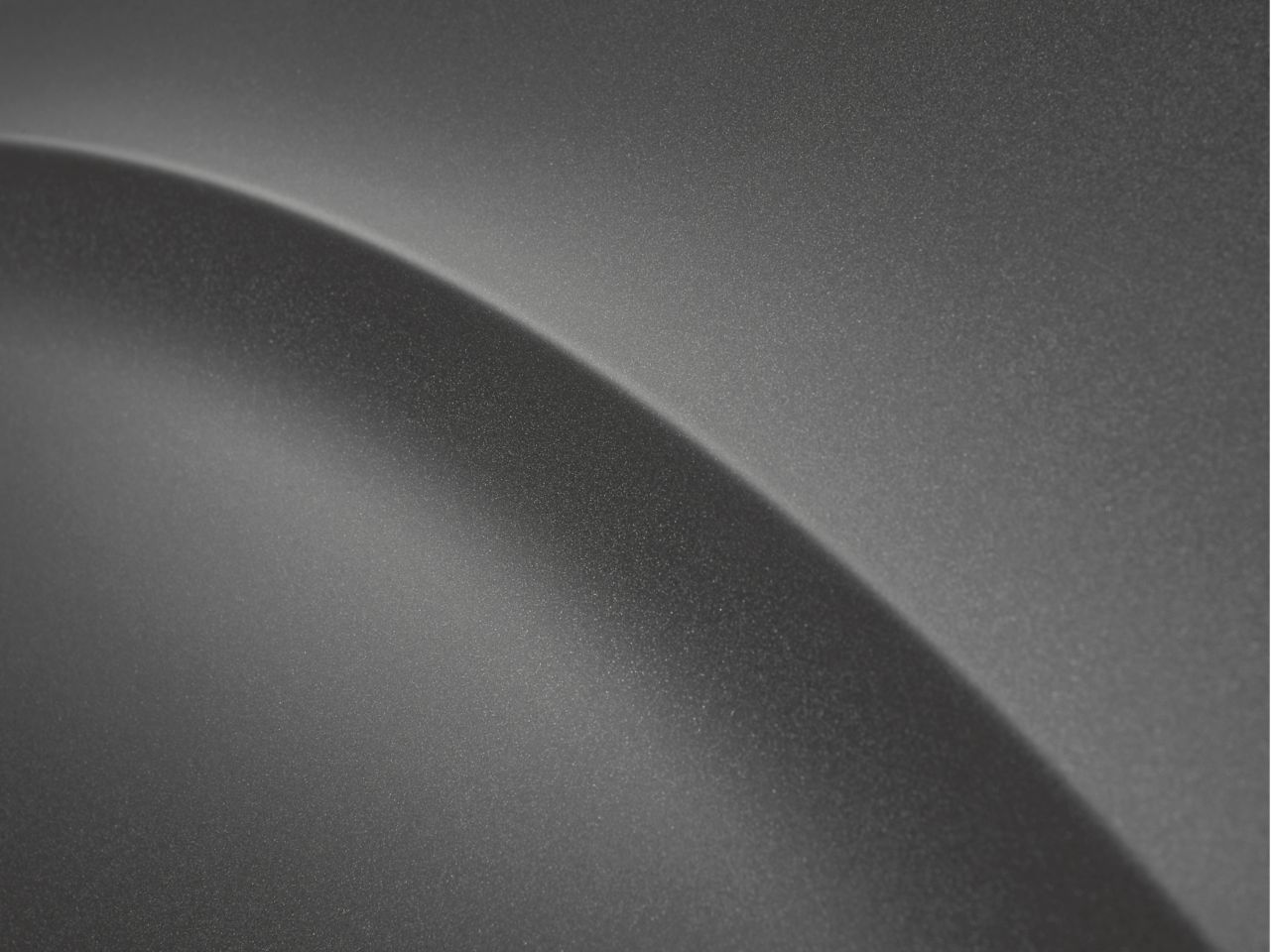 It is a black and white photo of a gray surface.