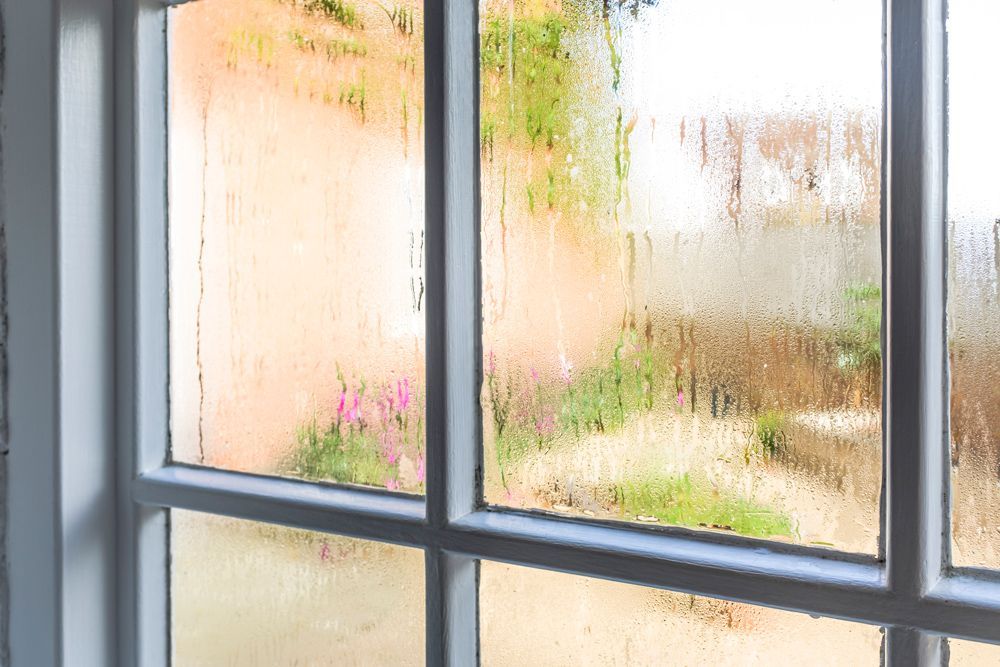 A window with a lot of condensation on it.