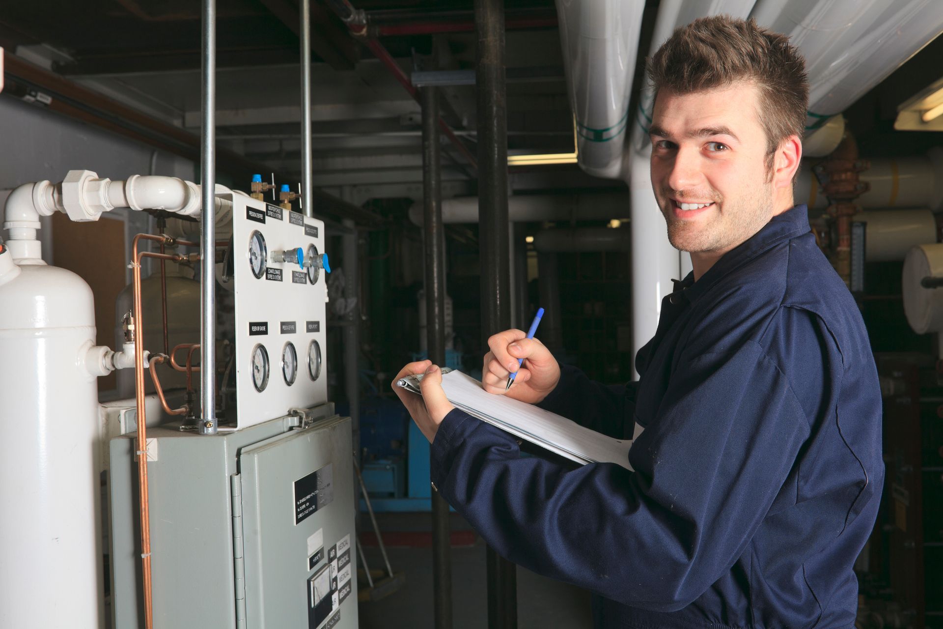 HVAC technician performing a furnace tune-up in a Rochester home to prepare for the winter season.