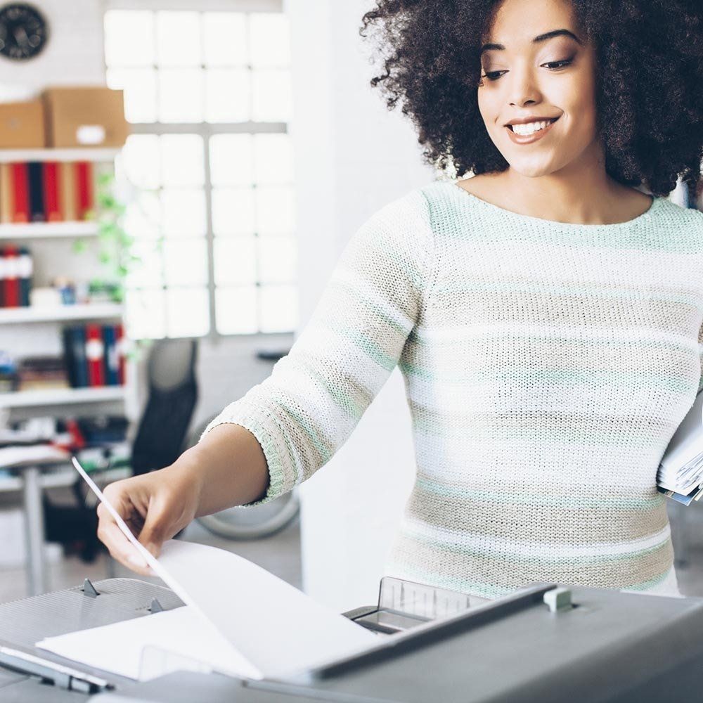 A Woman Using The Copier Machine — Memphis, TN — American Photocopy