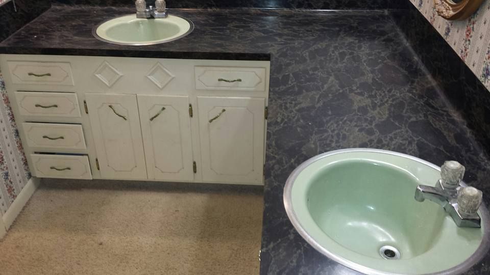 A bathroom with two sinks and a black counter top.