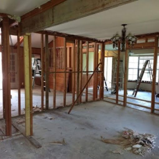 A room with a ladder and a chandelier in it