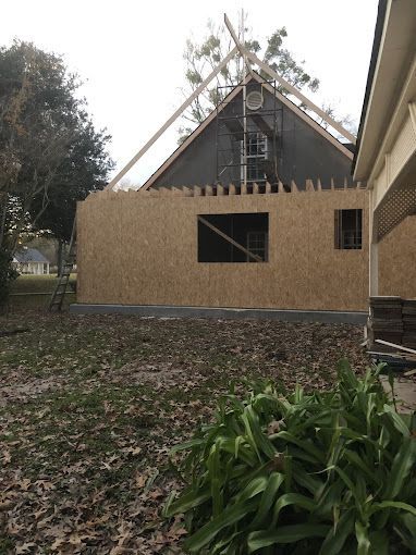 A house is being built with scaffolding on the roof.