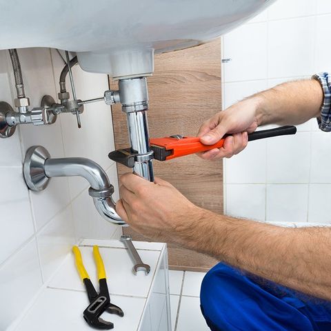 Male Plumber Fixing Sink in Bathroom — Pleasant Valley, NY — Harris Plumbing