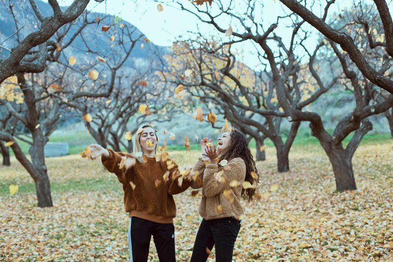 Two Woman Playing On Fallen Leaves — Nashville, TN — Kaily's Tree