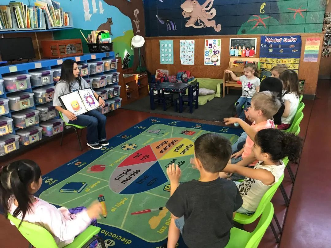 Teacher and Students in Library — Sacramento, CA — Tot Town Child Development Center, Inc.