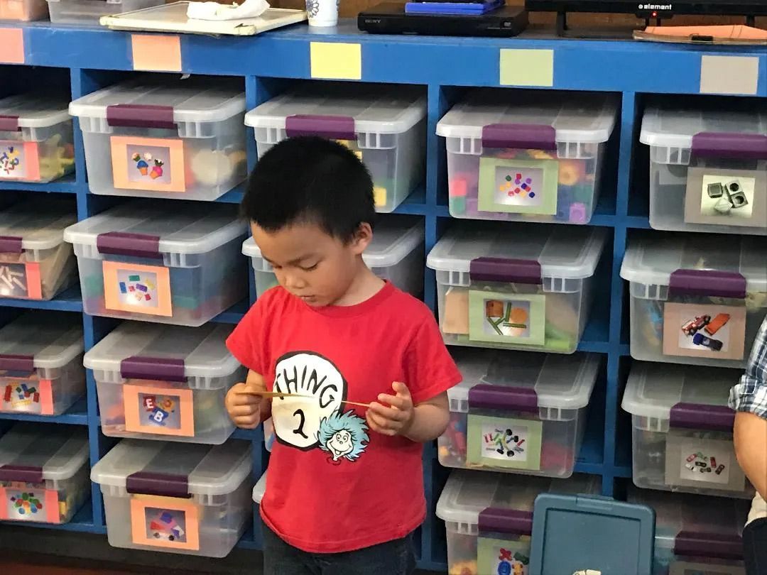 Child Reading a Paper — Sacramento, CA — Tot Town Child Development Center, Inc.