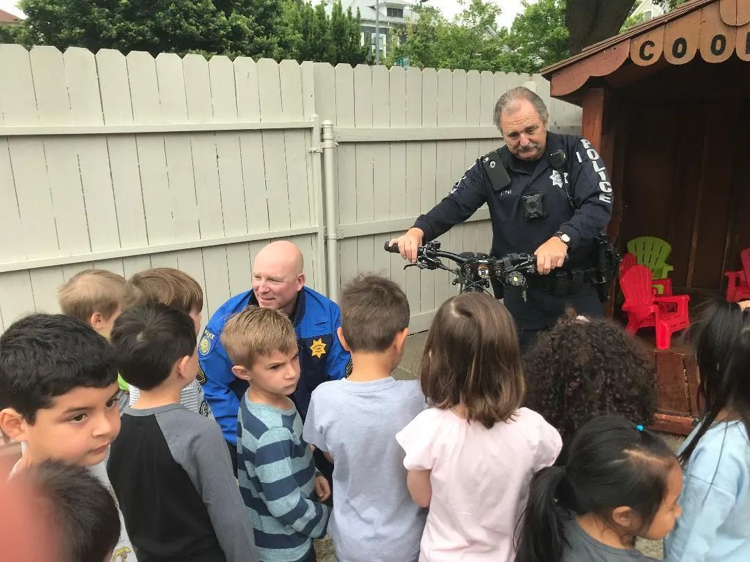 Officer Talking to Children — Sacramento, CA — Tot Town Child Development Center, Inc.