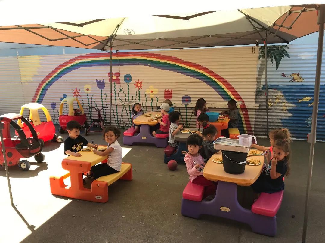 Children Sitting at Picnic Tables — Sacramento, CA — Tot Town Child Development Center, Inc.
