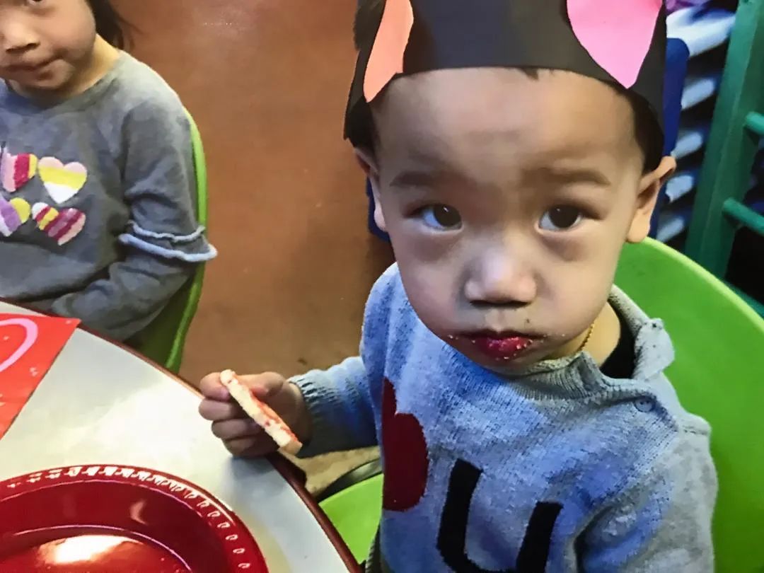 Child Eating a Snack — Sacramento, CA — Tot Town Child Development Center, Inc.