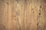 Wooden planks, vertical, varying shades of brown, with knots and grain detail.