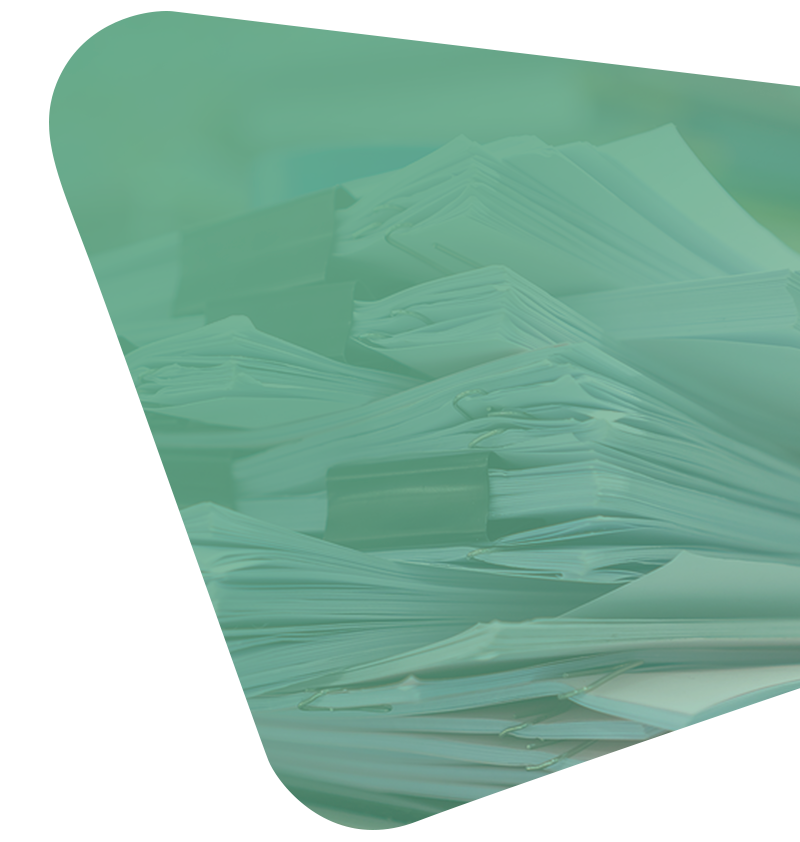 A stack of paper documents held together by black binder clips, viewed through a soft green-tinted overlay.
