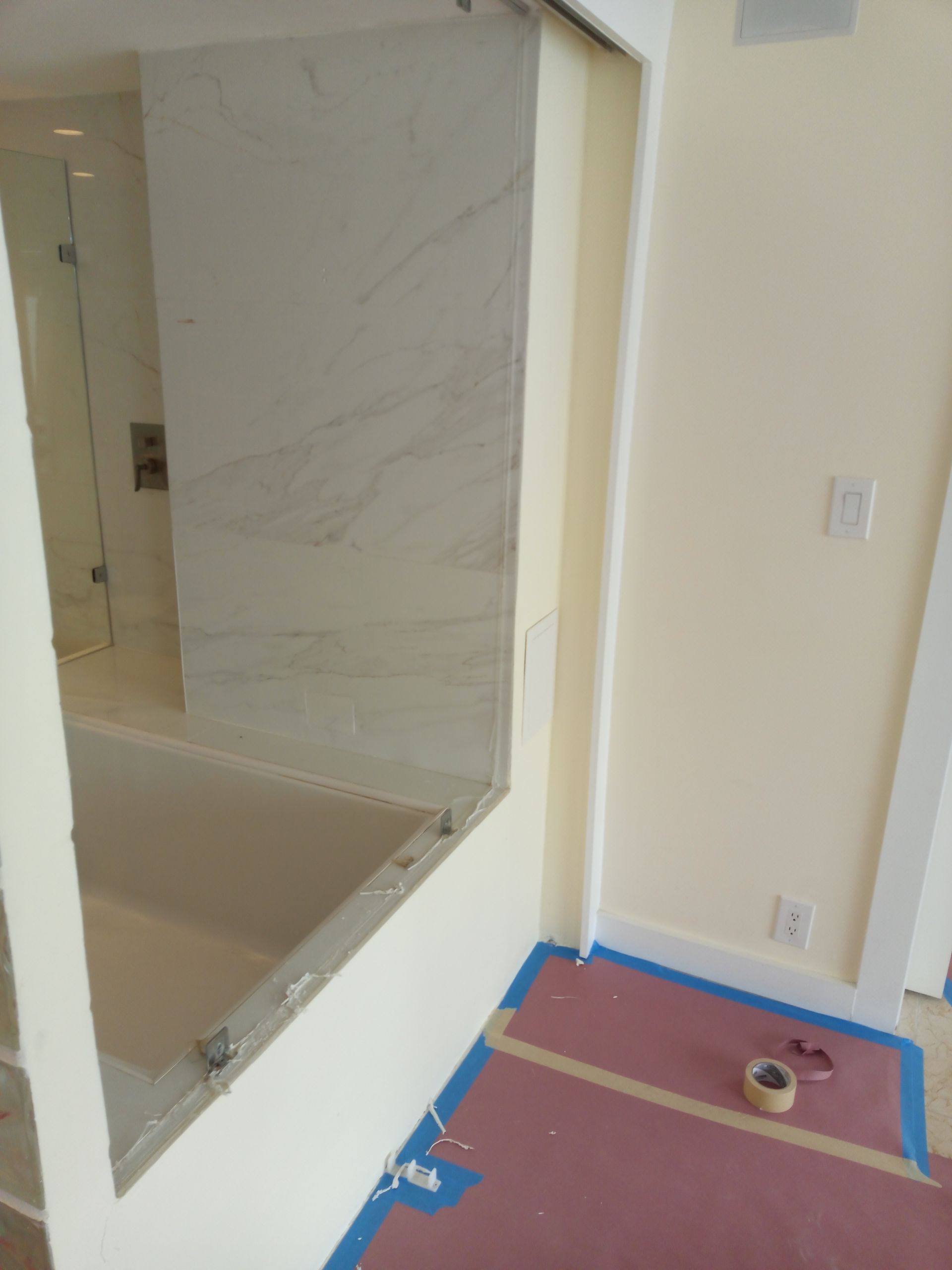 A bathroom with a large mirror on the wall