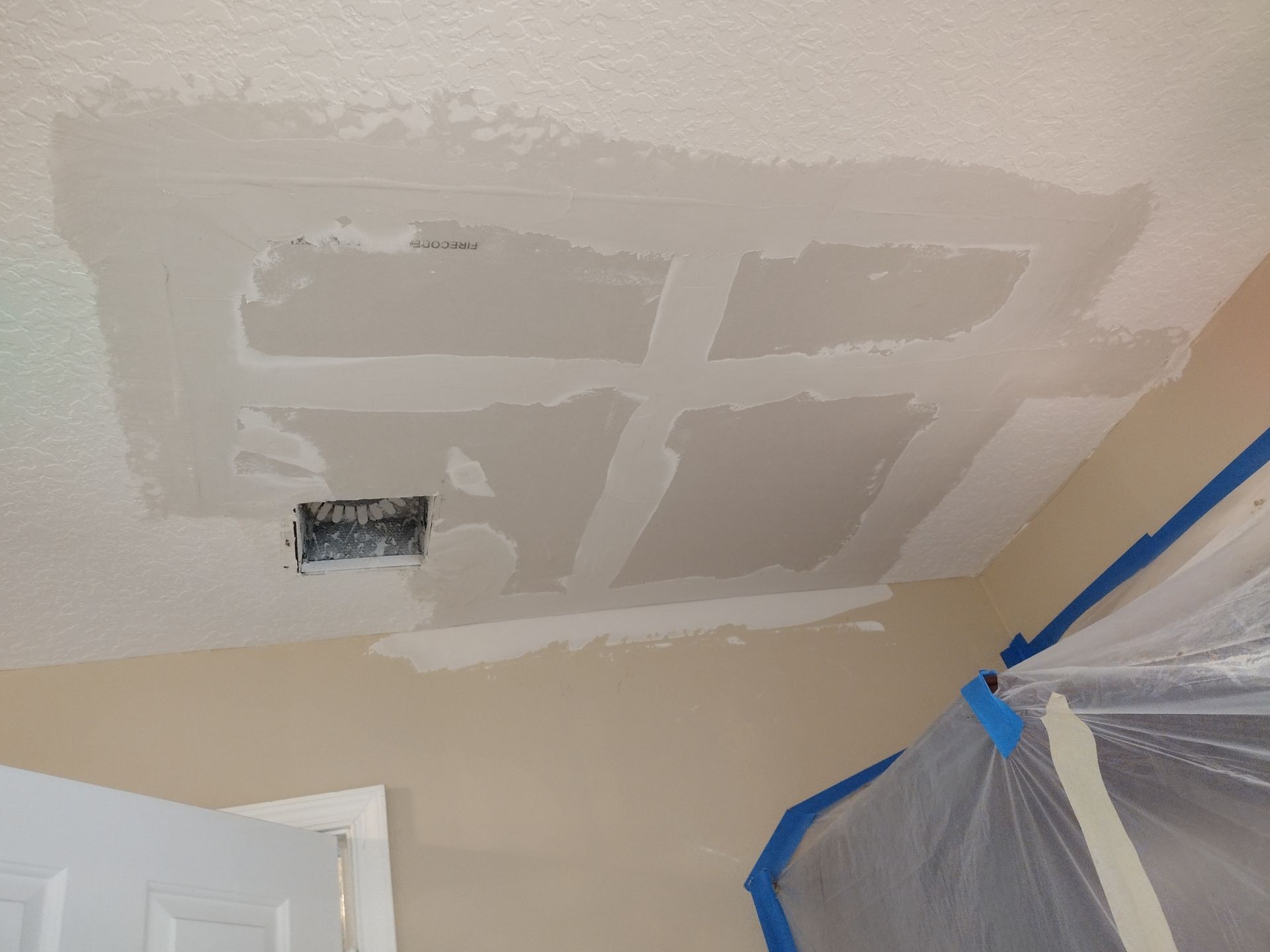 A room with a ceiling that is being painted