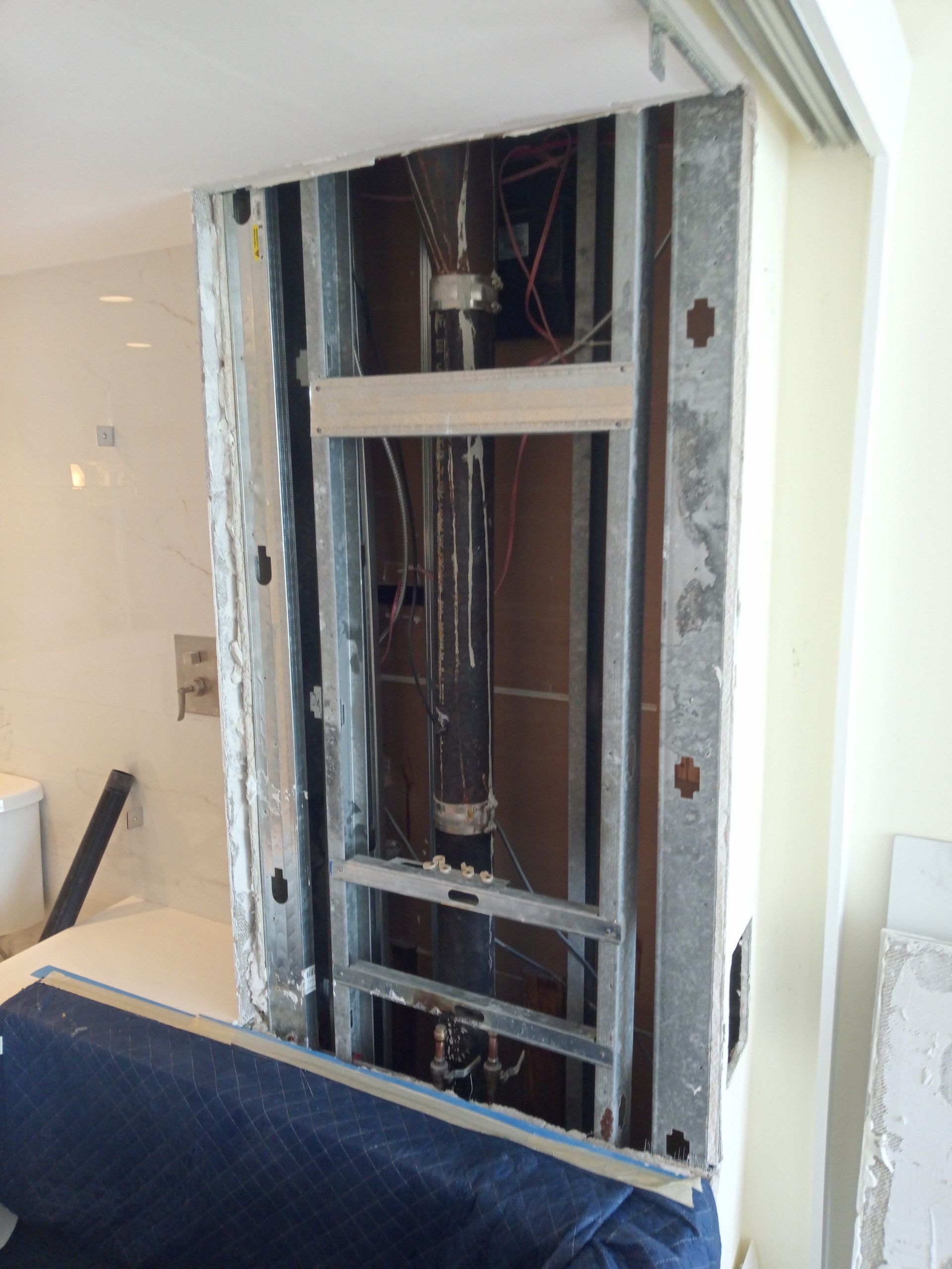 A wall that is being remodeled in a bathroom
