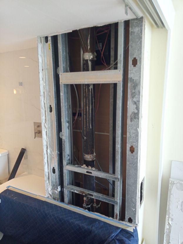 A wall that is being remodeled in a bathroom