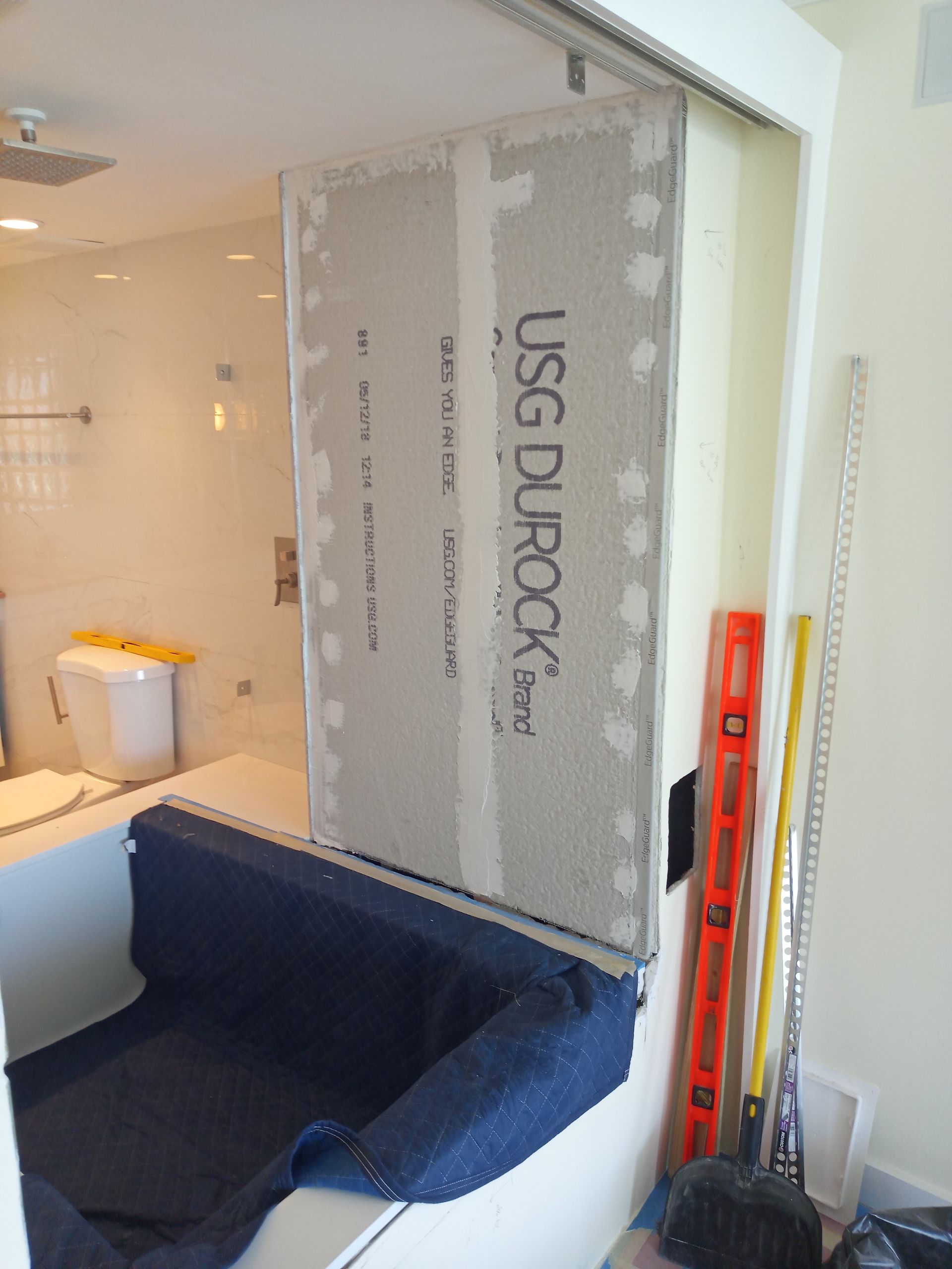 A bathroom with a usg durock panel on the wall
