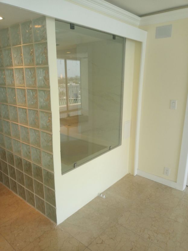 A room with a glass wall and a window