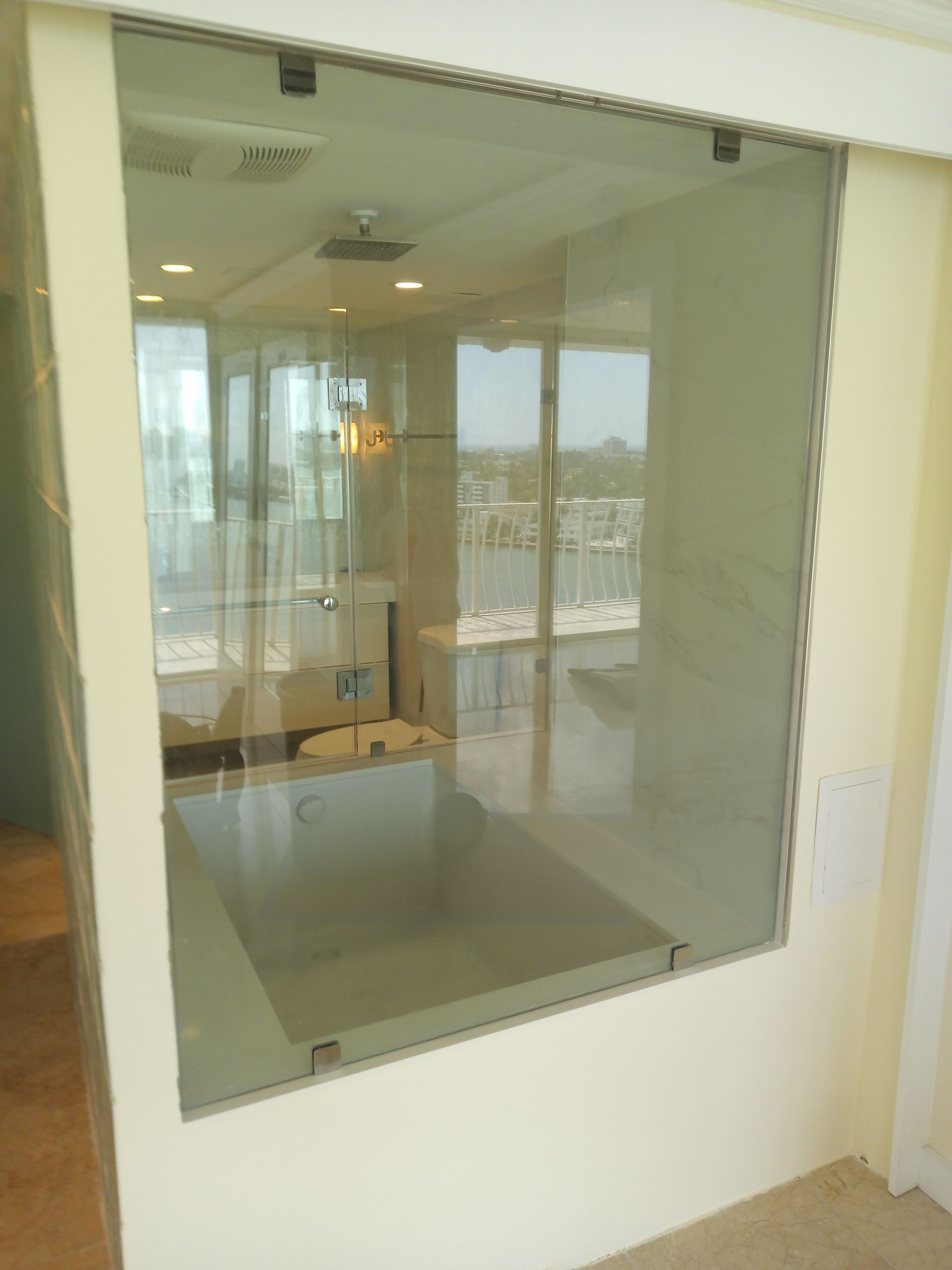 There is a large window in the middle of a room.