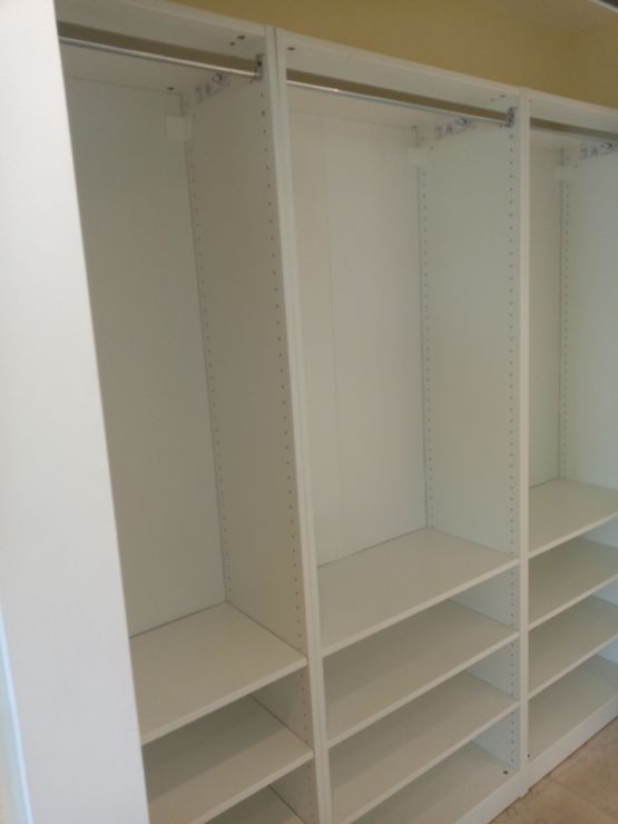 A closet with lots of shelves and hanging rods