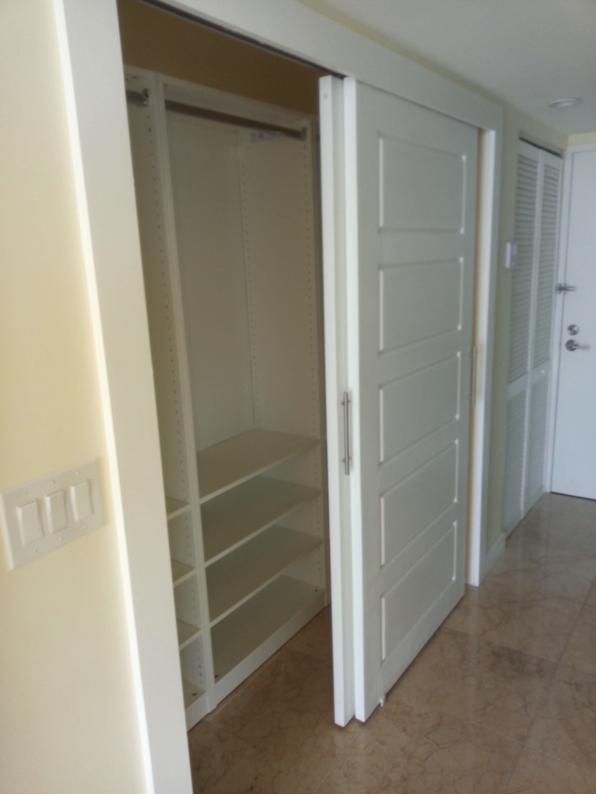 A closet with sliding glass doors and shelves