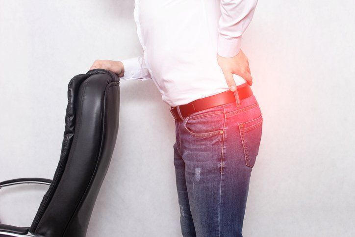 Woman Touching Her Back In Pain — Chattanooga, TN — Specialists In Pain Management
