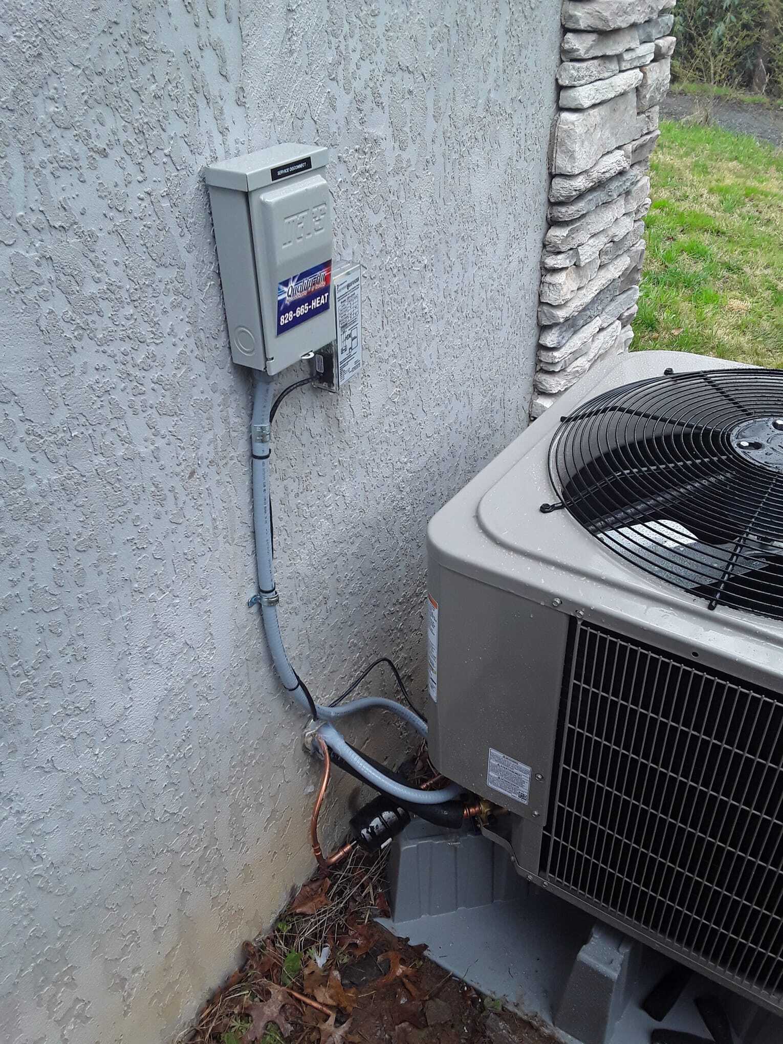 HVAC machine with sticker of Air Quality beside white wall — Asheville, NC — Quality Air