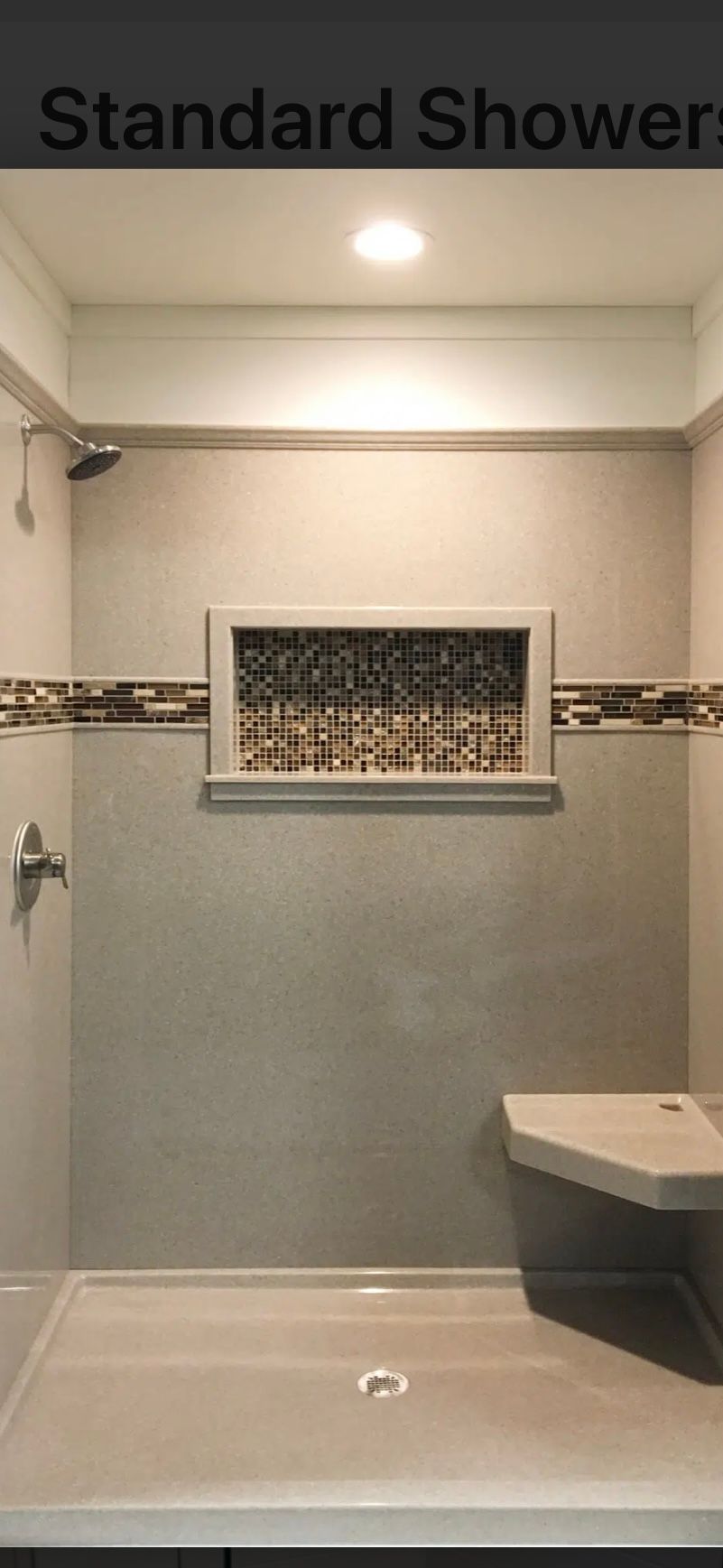 Standard shower with built-in bench, decorative tile, and glass block window.