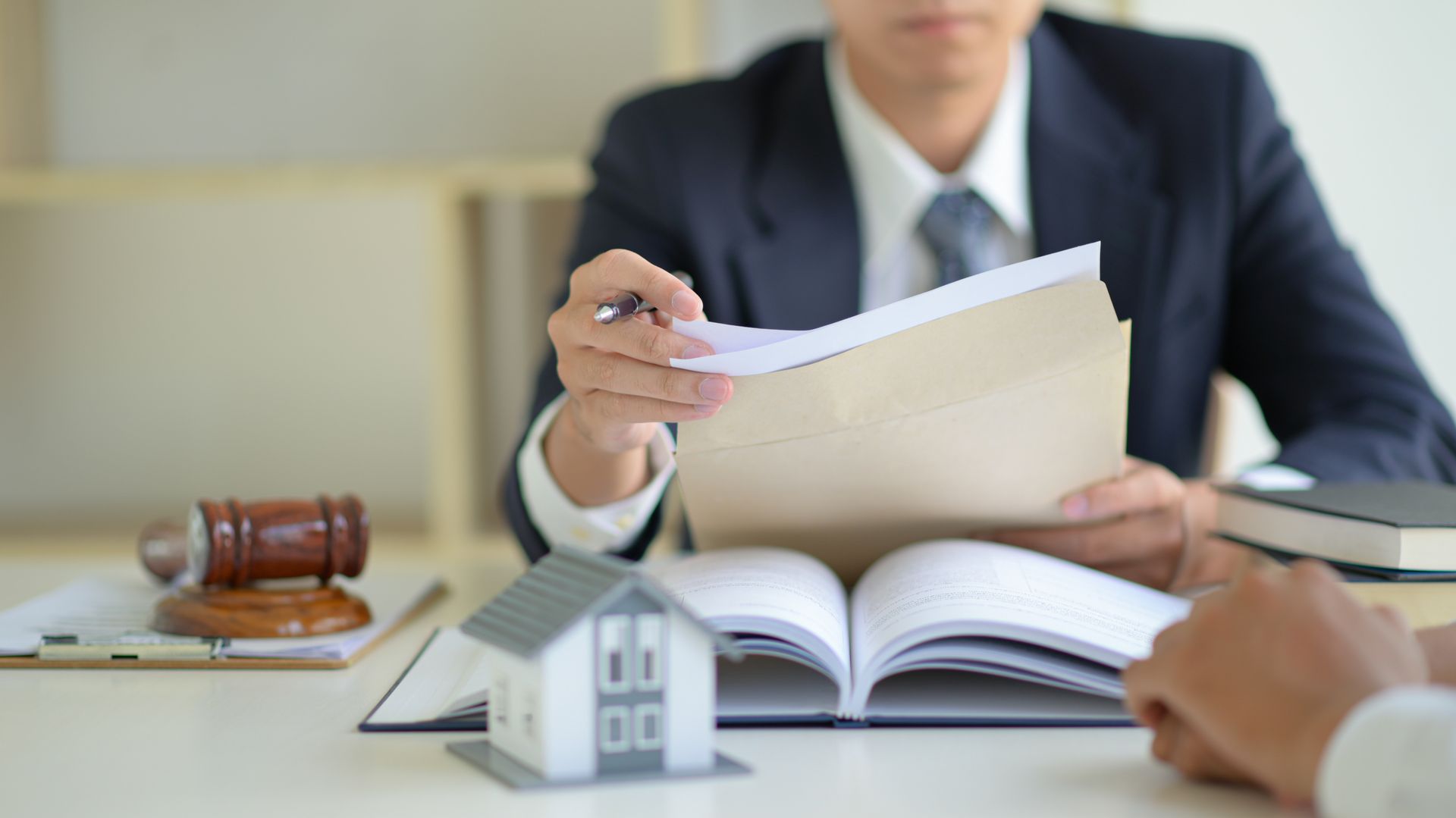 Lawyer showing documents to a client in a formal office setting.