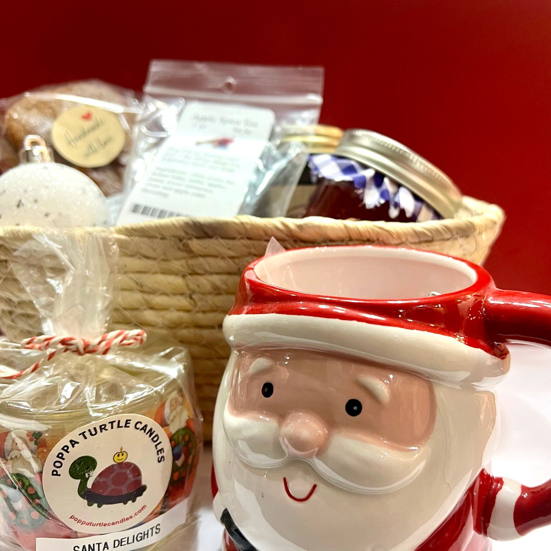 A santa mug sits next to a bag of santa turtle candles