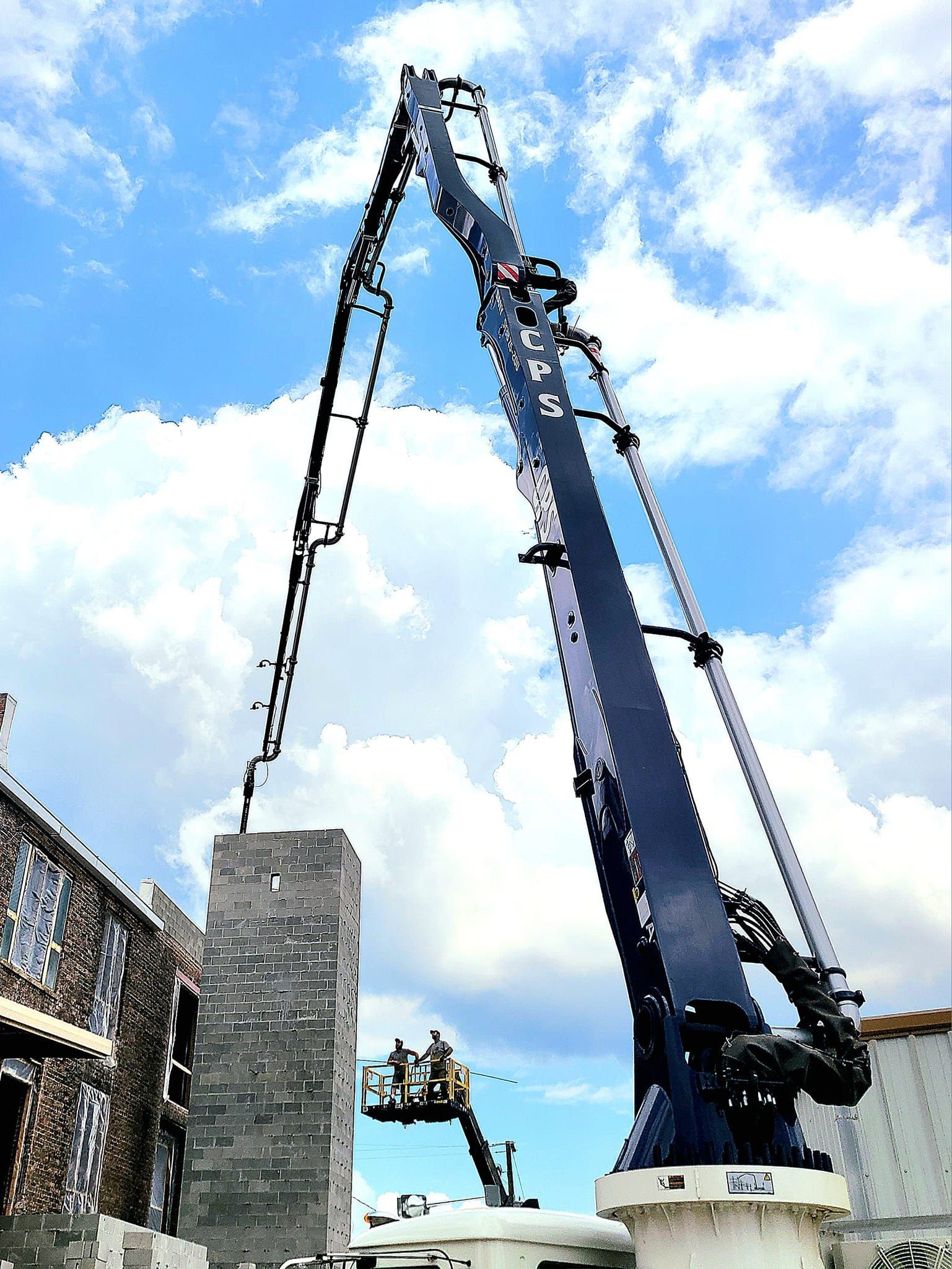 A large crane is lifting a large concrete block
