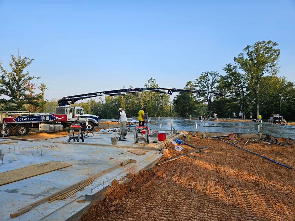 A construction site with a truck and a crane in the background.