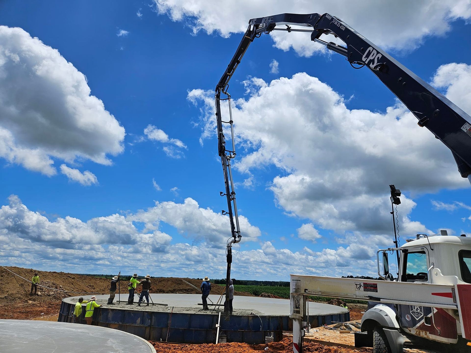A concrete pump is being used to pour concrete on a construction site.