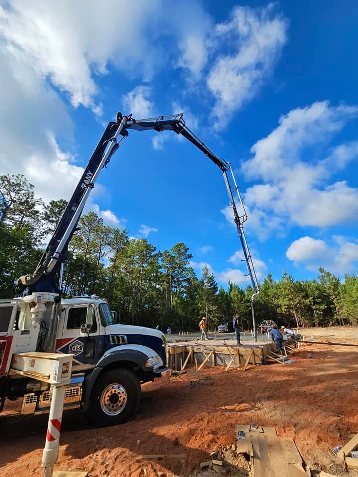 A concrete pump truck is pumping concrete on a construction site.