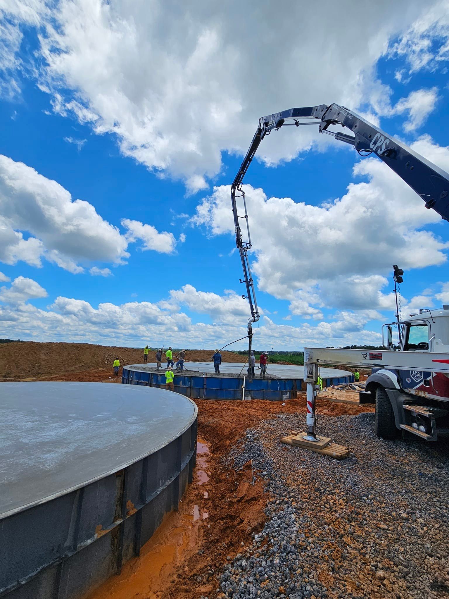 A concrete pump is being used to pour concrete on a construction site.