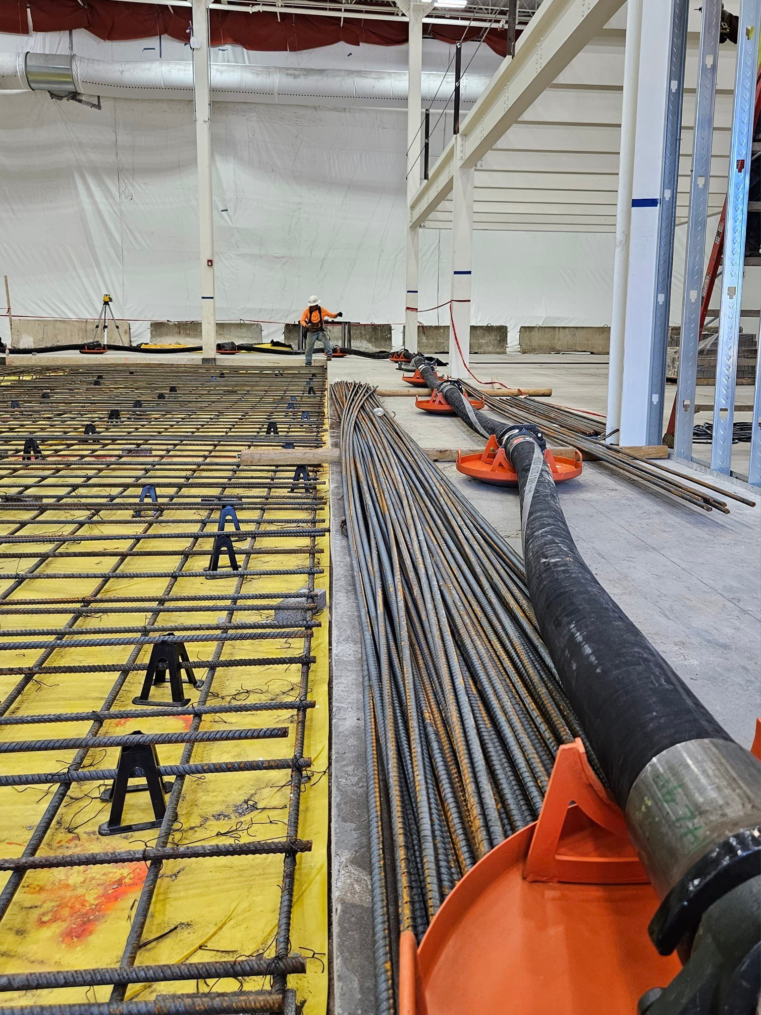 A hose is laying on the ground in a building under construction