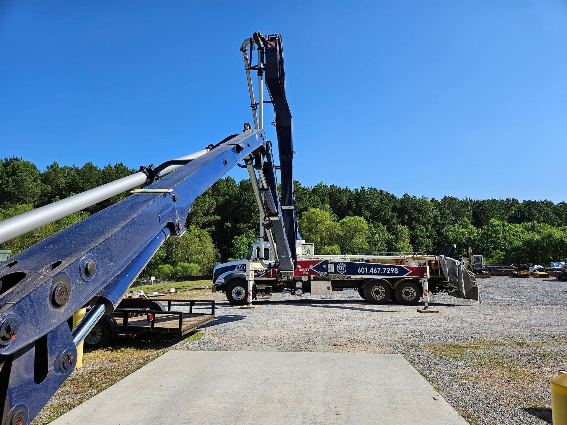 A concrete pump is being used to pump concrete into a concrete slab