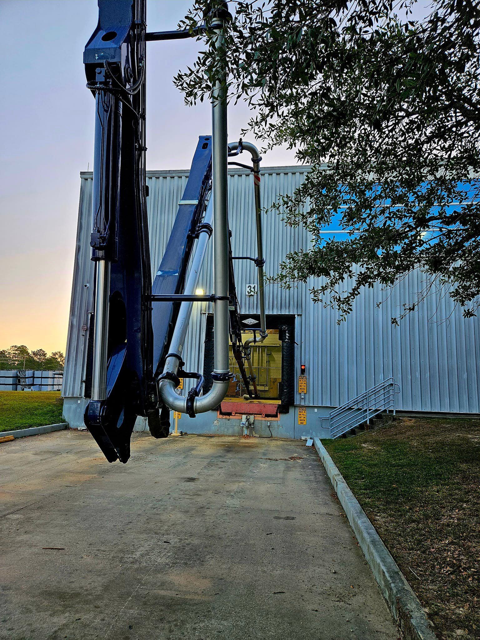 A large machine is sitting in front of a building.