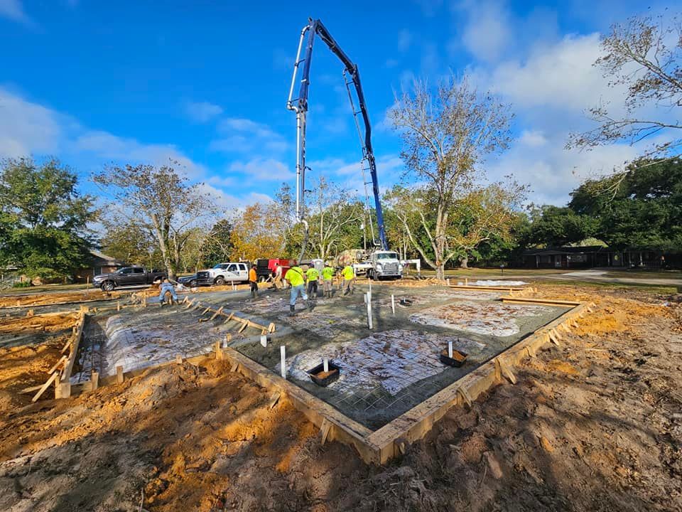 A concrete pump is being used to pour concrete into a foundation.