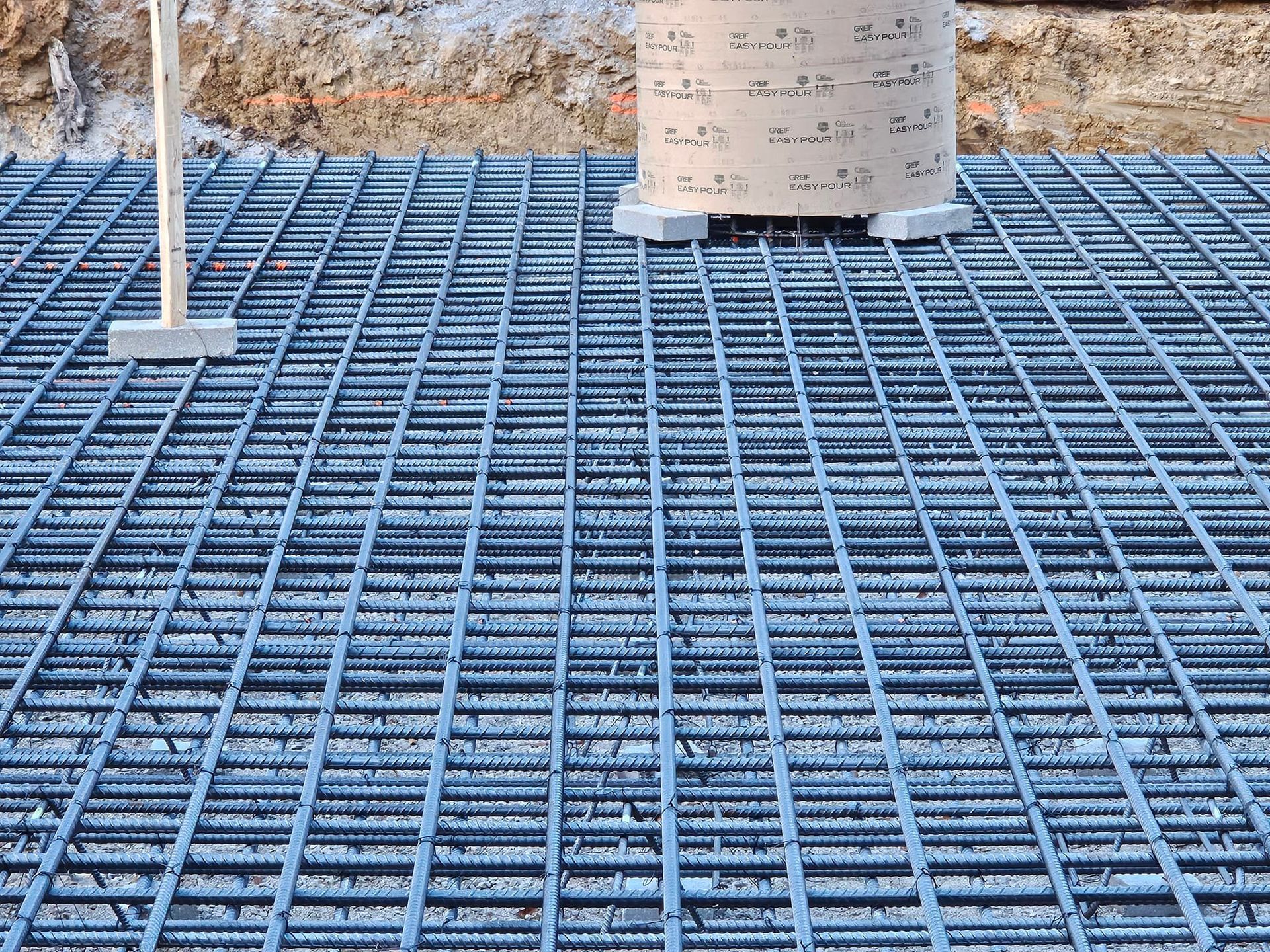 A close up of a metal grid on a construction site.