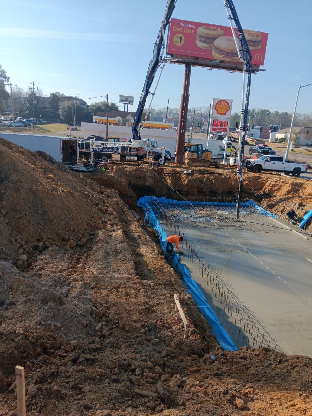 A construction site with a large billboard in the background.