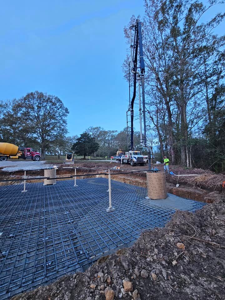 A concrete pump is being used to pour concrete on a construction site.