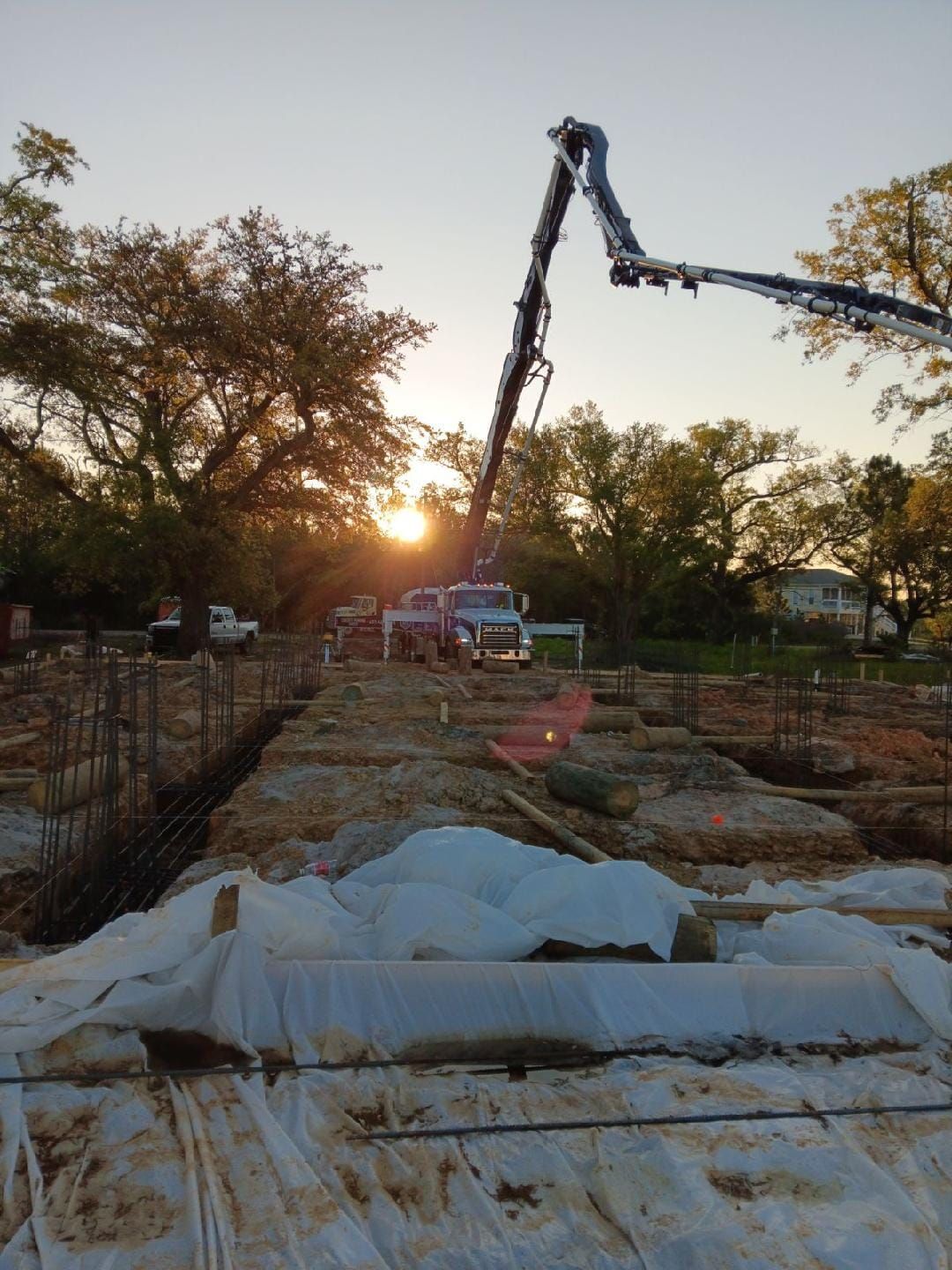 A concrete pump is being used to pour concrete on a construction site.