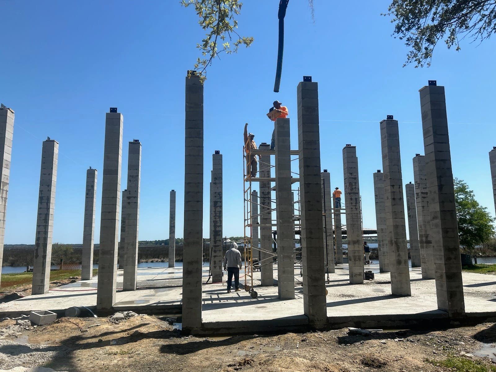 A group of concrete pillars are being built on a construction site.