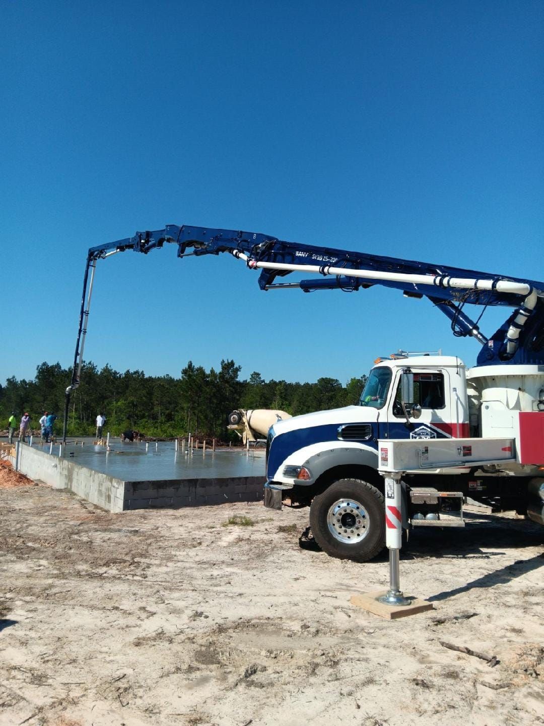 A blue and white truck with a crane attached to it