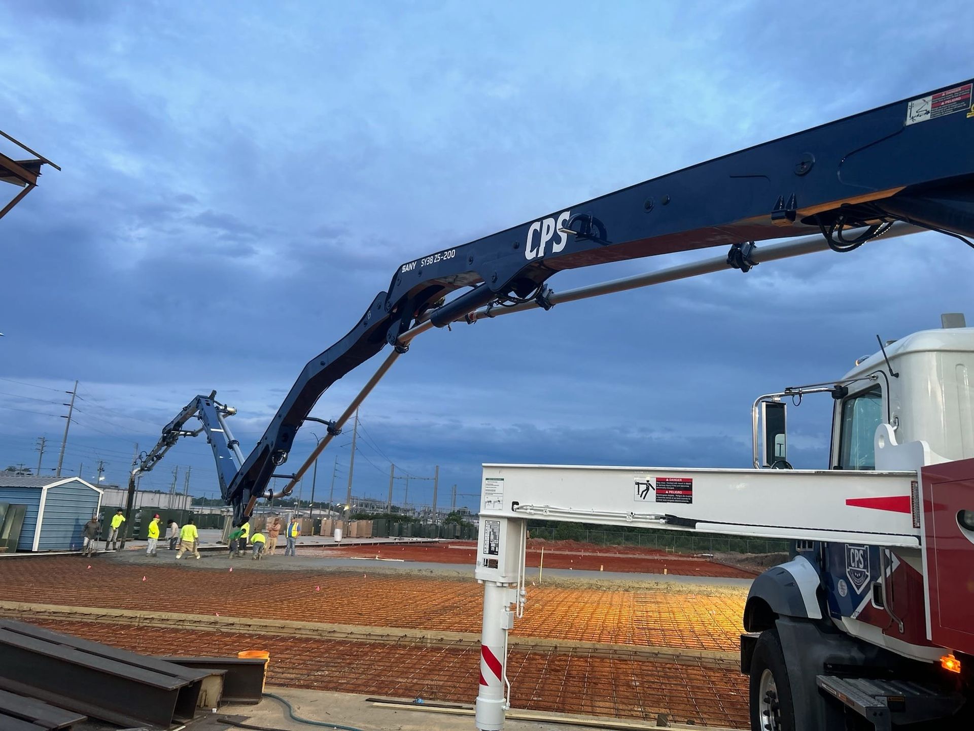 A crane is being used to pump concrete into a construction site.