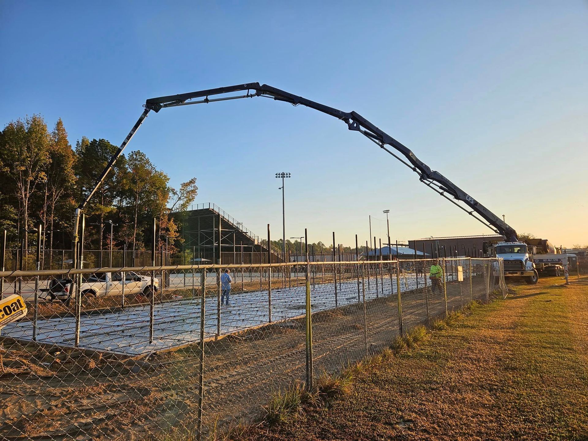 A concrete pump is being used to pour concrete on a construction site.