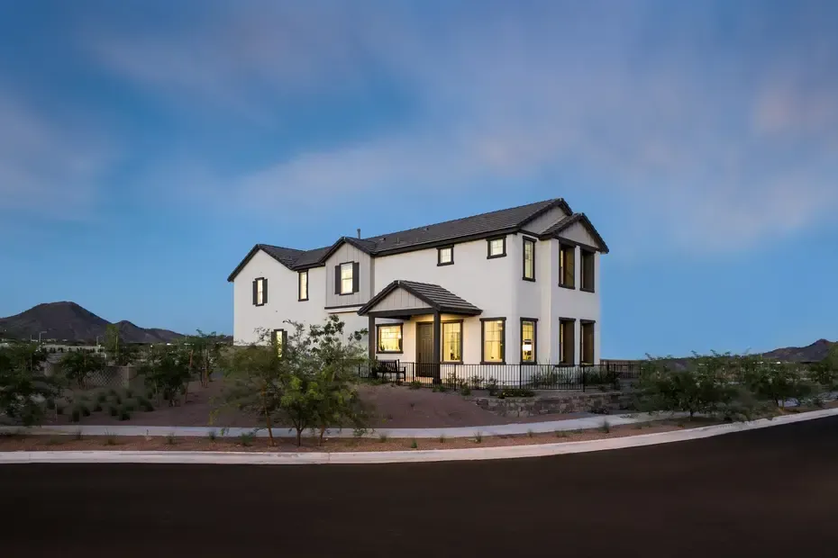 A large white house is sitting on top of a hill.